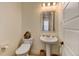 Clean and modern bathroom with pedestal sink and toilet at 8984 Eagle River St, Littleton, CO 80125