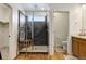 Bathroom featuring a walk-in shower and neutral tile at 8984 Eagle River St, Littleton, CO 80125