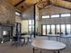 Spacious clubhouse interior with fireplace, tables, and chairs for community gatherings at 8984 Eagle River St, Littleton, CO 80125