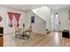 Bright dining area with hardwood floors, a table, and a view of the front entryway at 8984 Eagle River St, Littleton, CO 80125