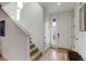 Bright entryway with hardwood floors, a staircase, and a white front door with sidelight window at 8984 Eagle River St, Littleton, CO 80125