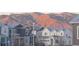 View of the neighborhood with houses in front of mountains at 8984 Eagle River St, Littleton, CO 80125