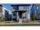 Two-story modern home with gray siding and a front porch at 8984 Eagle River St, Littleton, CO 80125