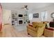 Living room with a fireplace, built-in shelves, and hardwood floors at 8984 Eagle River St, Littleton, CO 80125