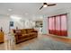 Living room with hardwood floors, large windows, and a ceiling fan at 8984 Eagle River St, Littleton, CO 80125