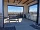 Outdoor kitchen area featuring stainless steel appliances, a built-in grill, and seating at 8984 Eagle River St, Littleton, CO 80125