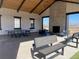 Covered patio area with stone fireplace, comfortable seating, and a table tennis set at 8984 Eagle River St, Littleton, CO 80125