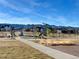 Playground with swings, slides, and mountain views, perfect for community enjoyment at 8984 Eagle River St, Littleton, CO 80125