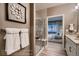 Bathroom featuring glass-enclosed shower with seating and a doorway view into bedroom at 920 W 128Th Pl, Westminster, CO 80234