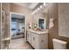 Bathroom featuring double vanity and walk-in shower, seen through doorway to bedroom at 920 W 128Th Pl, Westminster, CO 80234