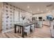 Dining area adjacent to a modern kitchen, featuring stylish seating and plenty of natural light at 920 W 128Th Pl, Westminster, CO 80234