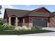Charming single-Gathering home featuring a stone and siding exterior, attached garage, and manicured landscaping at 920 W 128Th Pl, Westminster, CO 80234
