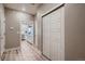 Bright hallway leading to a modern kitchen, featuring sleek flooring and ample closet space at 920 W 128Th Pl, Westminster, CO 80234