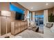Bright living room with modern cabinet, large TV, and comfortable seating area near sliding glass doors at 920 W 128Th Pl, Westminster, CO 80234