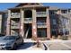Exterior view of a light brown multi-story apartment building with parking at 804 Summer Hawk Dr # 9106, Longmont, CO 80504