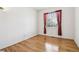 Hardwood bedroom with window and red curtains at 10383 Coal Ridge St, Firestone, CO 80504