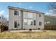 Back exterior view of the home highlighting its large windows and inviting backyard space at 10383 Coal Ridge St, Firestone, CO 80504