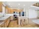 Bright kitchen featuring a center island, stainless steel appliances, and hardwood flooring at 10383 Coal Ridge St, Firestone, CO 80504