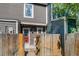 Backyard features a wood fence, gate, and red door to the house at 1068 Milo Cir # A, Lafayette, CO 80026