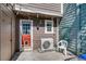 Cozy backyard with red door, string lights, and AC unit at 1068 Milo Cir # A, Lafayette, CO 80026