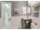 Cozy bathroom featuring vanity sink, wall mirror, and open doorway at 1068 Milo Cir # A, Lafayette, CO 80026