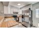 Bright kitchen showcasing white cabinets, stainless steel appliances, and ample counter space at 1068 Milo Cir # A, Lafayette, CO 80026