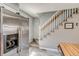 Kitchen area featuring stainless steel refrigerator and staircase with white banister and gray walls at 1068 Milo Cir # A, Lafayette, CO 80026
