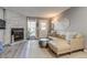 Cozy living room featuring a stone fireplace, neutral decor, and a comfortable leather sofa at 1068 Milo Cir # A, Lafayette, CO 80026