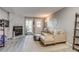 Comfortable living room showcasing a stone fireplace, stylish decor, and ample natural light at 1068 Milo Cir # A, Lafayette, CO 80026