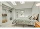 Bright main bedroom featuring vaulted ceilings, skylights, and a walk-in closet with shelving at 1068 Milo Cir # A, Lafayette, CO 80026