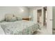 Bedroom with soft blue walls, floral quilt, and doorway view to bathroom and walk-in closet at 1068 Milo Cir # A, Lafayette, CO 80026