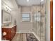 Bathroom features a granite vanity, a glass enclosed shower, and wood-look flooring at 1091 Colt Cir, Castle Rock, CO 80109