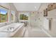 Luxurious bathroom featuring a soaking tub and glass enclosed shower with picturesque outdoor views at 1091 Colt Cir, Castle Rock, CO 80109
