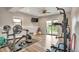 Home gym with sliding doors to the patio, gym equipment, and a ceiling fan at 1091 Colt Cir, Castle Rock, CO 80109