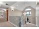 Hallway with carpet flooring, a chandelier, and rod iron railing at 1091 Colt Cir, Castle Rock, CO 80109