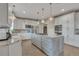Bright kitchen features custom cabinets, granite countertops, stainless steel appliances, and a large center island at 1091 Colt Cir, Castle Rock, CO 80109