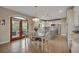 Bright kitchen with a central island, stainless steel appliances, and an adjacent breakfast area with deck access at 1091 Colt Cir, Castle Rock, CO 80109