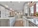Bright kitchen with white cabinets, stainless steel appliances, and granite countertops with a central island and pendant lights at 1091 Colt Cir, Castle Rock, CO 80109