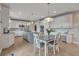 Spacious kitchen with white cabinets, stainless steel appliances, and granite countertops with an island and pendant lights at 1091 Colt Cir, Castle Rock, CO 80109