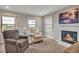 Cozy living room featuring a fireplace, plush armchairs, and views from the windows at 1091 Colt Cir, Castle Rock, CO 80109