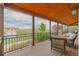 Covered porch with a view of the forest and comfortable outdoor seating at 1091 Colt Cir, Castle Rock, CO 80109