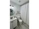 Updated bathroom with modern fixtures, a white shower curtain, and bright lighting at 4178 E 94Th Pl, Thornton, CO 80229