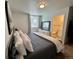 Inviting bedroom featuring plush bedding, neutral tones, and an ensuite bathroom for added privacy at 4178 E 94Th Pl, Thornton, CO 80229