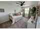Comfortable bedroom with a ceiling fan and ample natural light from a large window at 4178 E 94Th Pl, Thornton, CO 80229