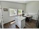 Eat in kitchen features an island, stainless steel appliances, white cabinets, and hardwood floors for a warm and inviting space at 4178 E 94Th Pl, Thornton, CO 80229