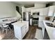 Beautiful kitchen with stainless steel appliances, center island, white cabinets and dining area with hardwood floors at 4178 E 94Th Pl, Thornton, CO 80229
