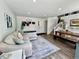 Spacious living room with comfortable sectional, rug, stairs to the second floor and a dining table with bench seating at 4178 E 94Th Pl, Thornton, CO 80229