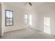 An empty bedroom featuring new carpet, fresh paint, and a black-framed window providing natural light at 1210 W 144Th Ct, Westminster, CO 80023