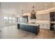 Modern kitchen with white and dark cabinetry, quartz countertops, and large island at 1210 W 144Th Ct, Westminster, CO 80023