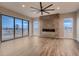 A spacious living room features a modern fireplace, a large fan and many large windows at 1210 W 144Th Ct, Westminster, CO 80023